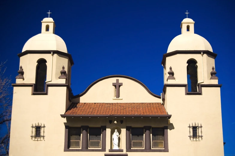 an old church with two tall towers with crosses on them