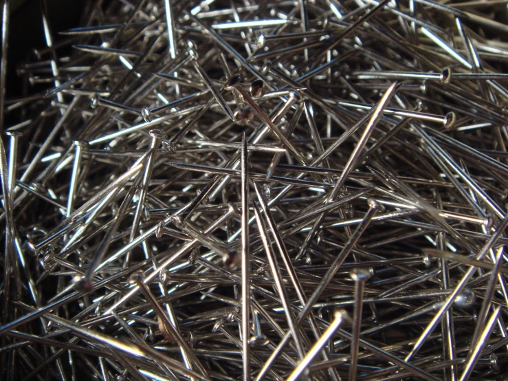 many pairs of nails laying on top of each other