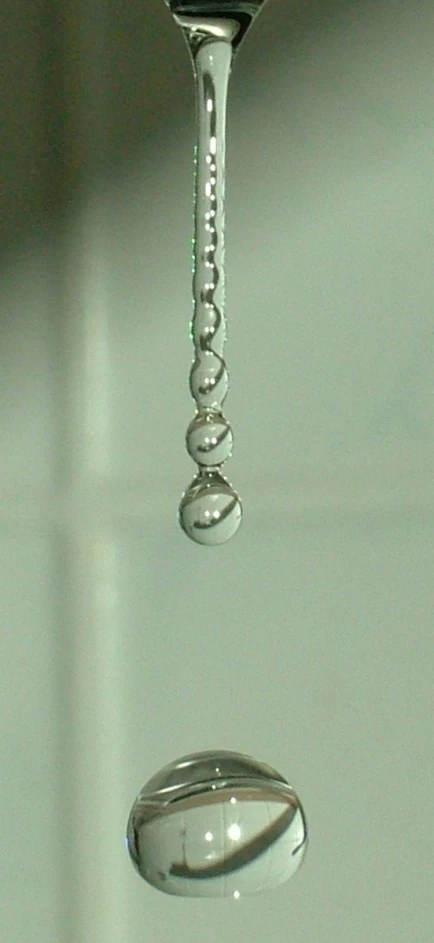 a small drop of water sitting on top of a sink