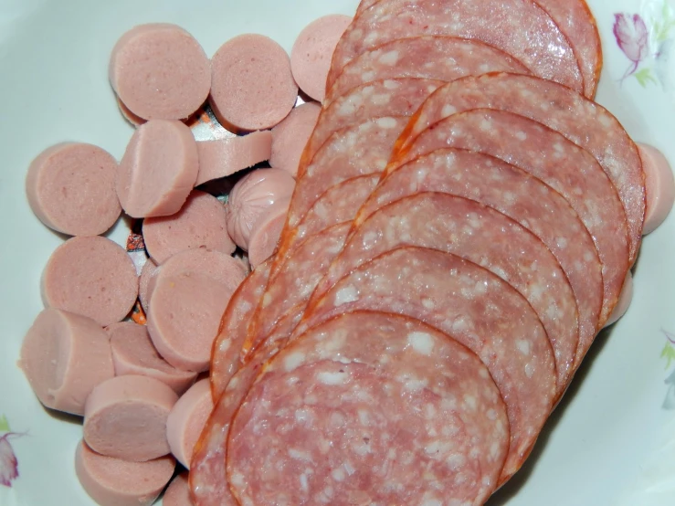 a plate has sausages on it and is ready to be sliced