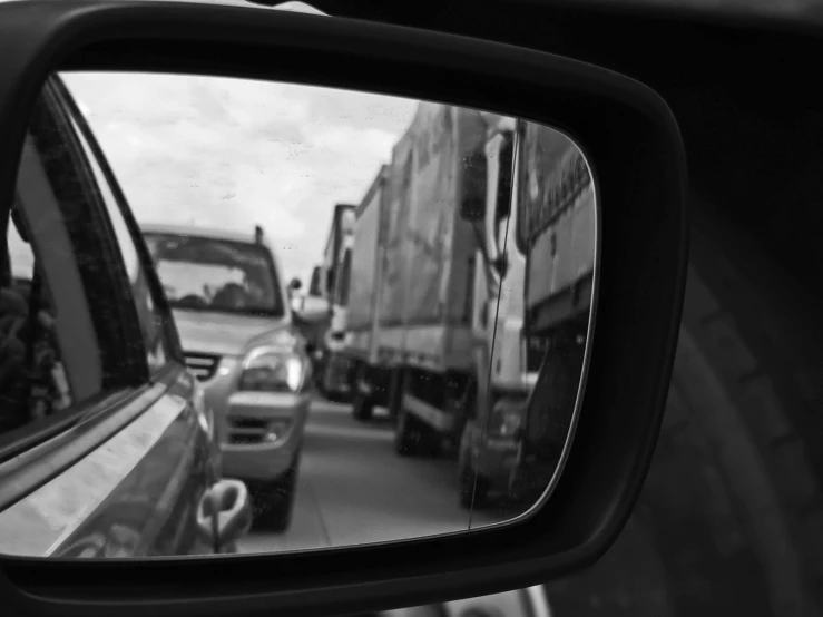 cars are traveling in both directions in the rear view mirror