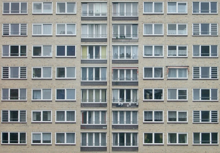 an apartment building with many windows on each level