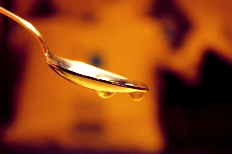 spoon full of syrup is seen floating in the air