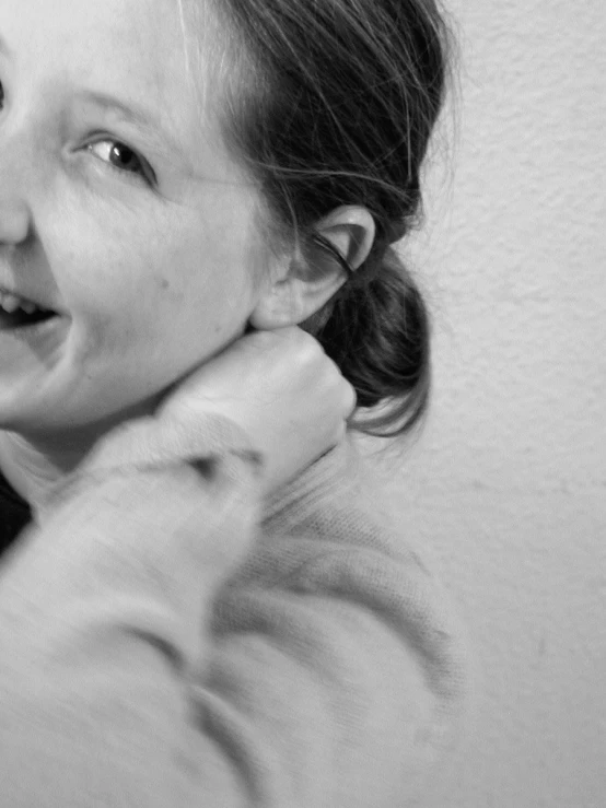 a black and white po of a girl brushing her teeth