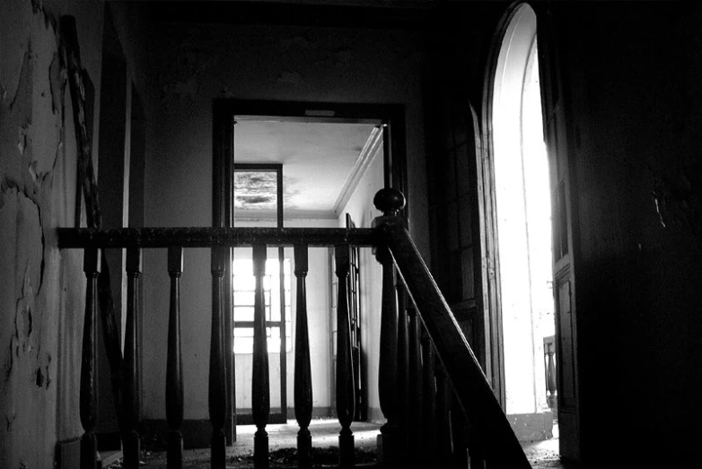the stairs leading to a hall in an old house