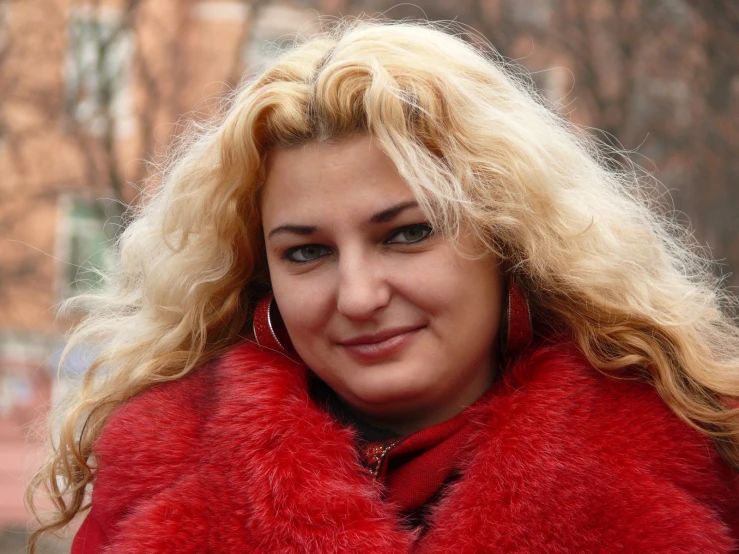 the woman is wearing a large red fur stole