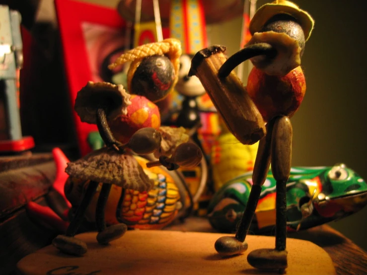 a wooden figure is playing a instrument next to a carnival clown