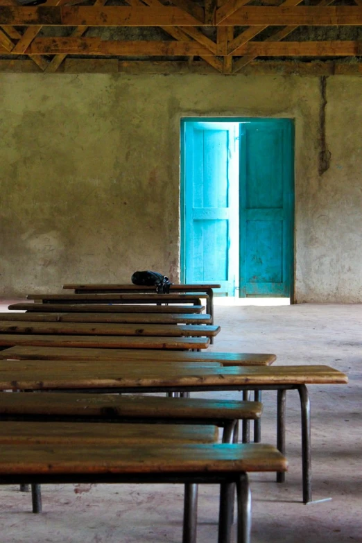 several benches in a building with a green door