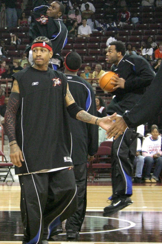 a basketball player holding a rope next to another player