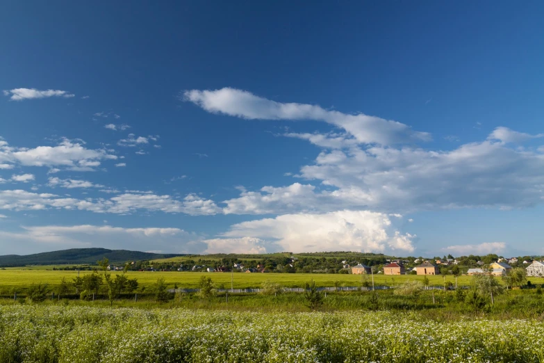 some white clouds and buildings under a blue sky