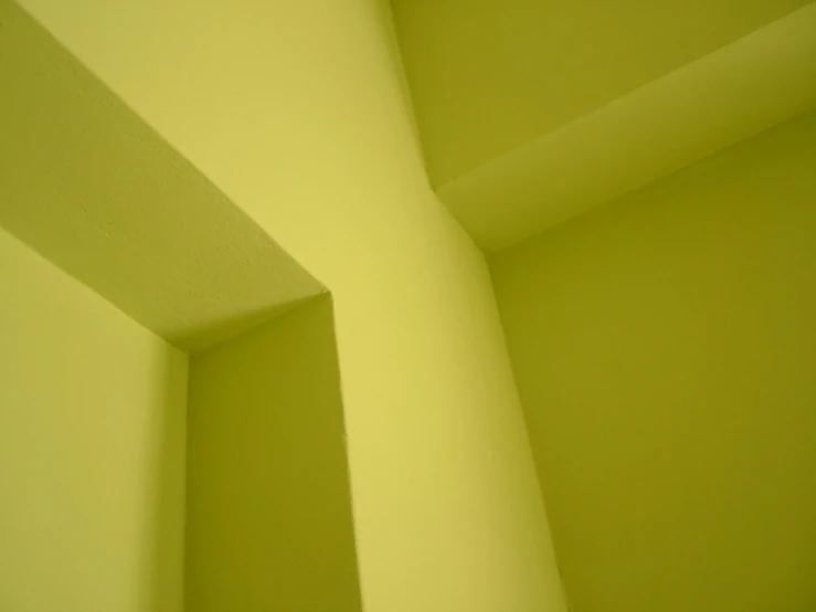 a white clock on a green wall in a room