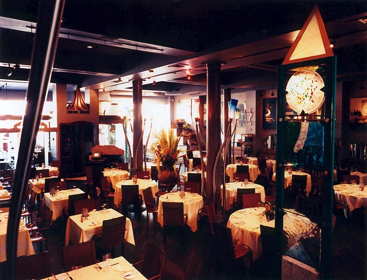 the clock is displayed behind the tables in the dining room