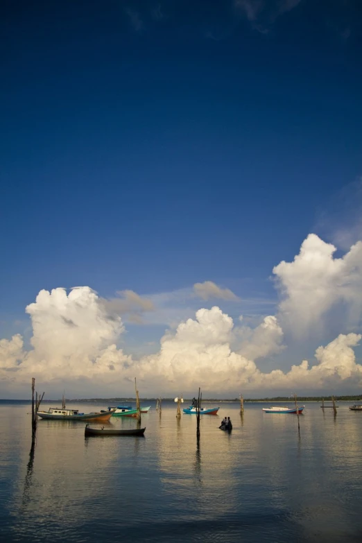 a beautiful blue sky with clouds over a harbor