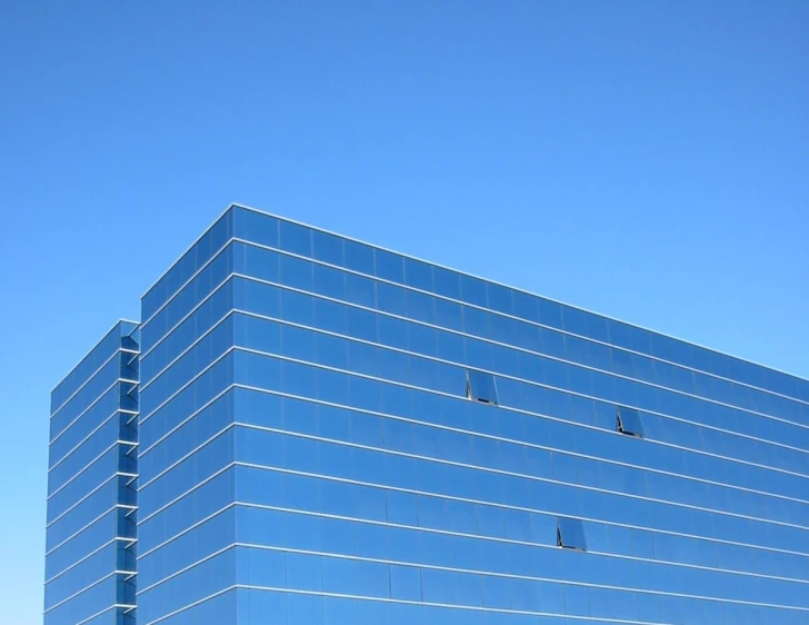 a large building in front of a blue sky