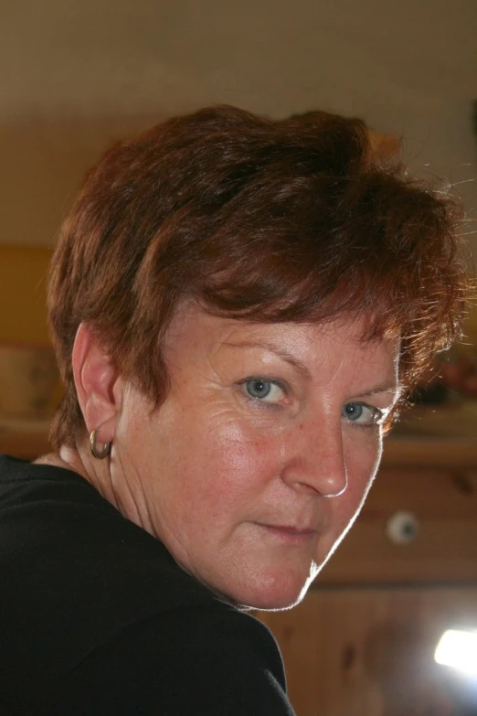 woman with brown hair wearing a black shirt