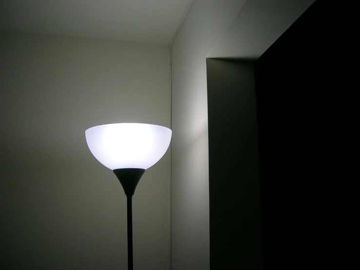 an empty room with a light on the floor