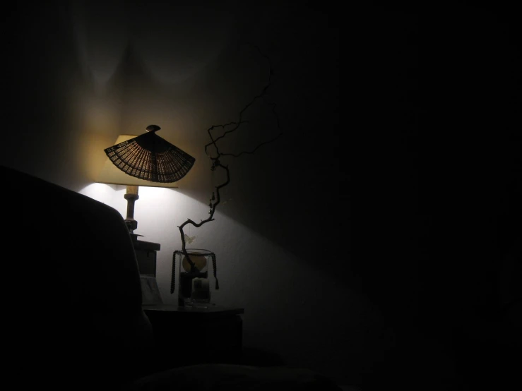 a small table lamp next to a black chair