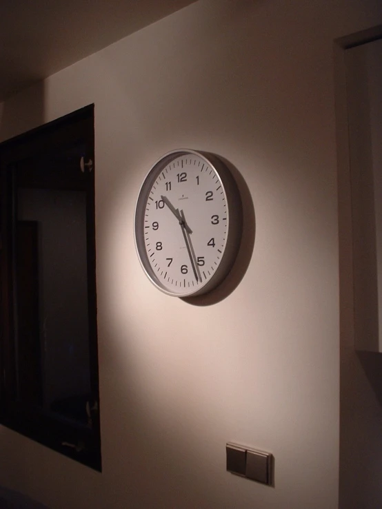 a clock mounted on the wall above it in a room