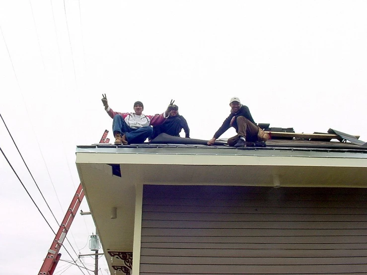 a group of people that are sitting on top of a building