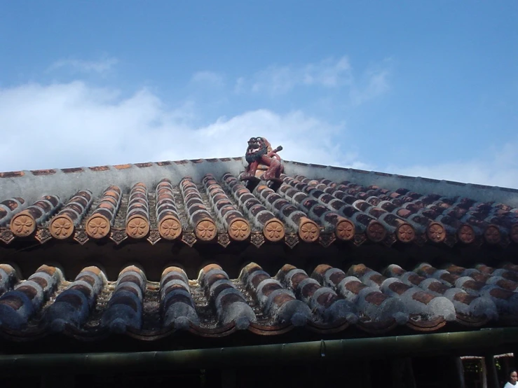 two roof tiles are attached to a metal rod