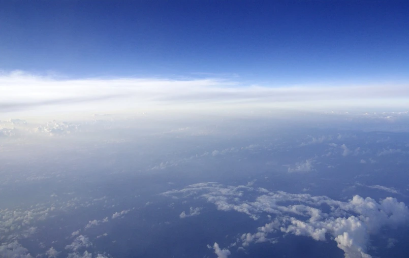 the view of clouds and the sky from an airplane window