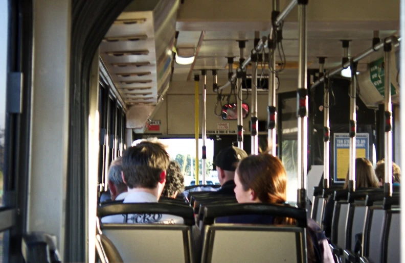 passengers are sitting on the back of a bus