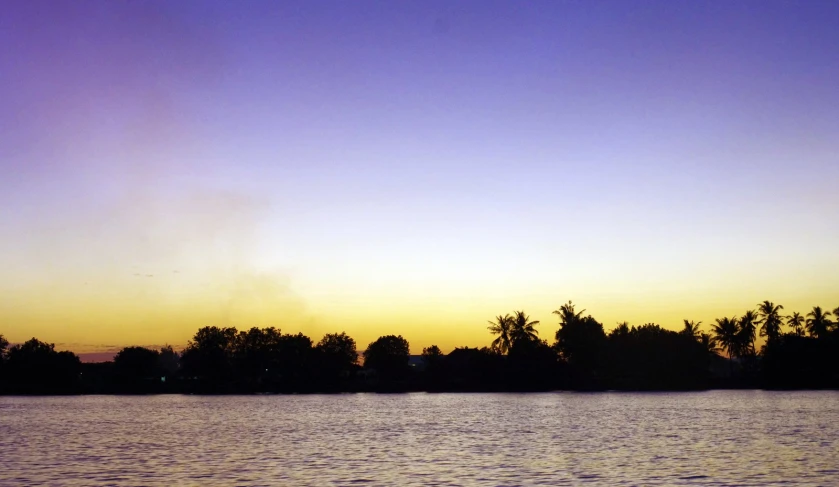 a view of the sky is shown with water in front