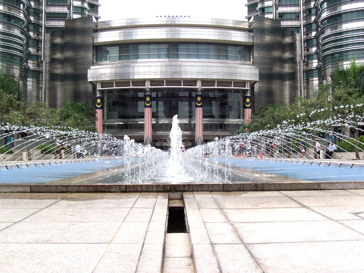 an outdoor fountain in front of a city building