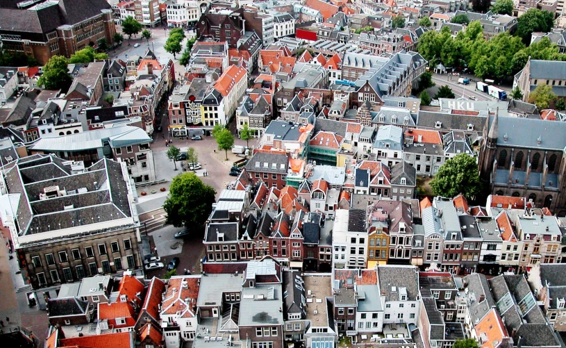 an aerial view of many buildings with orange roofs