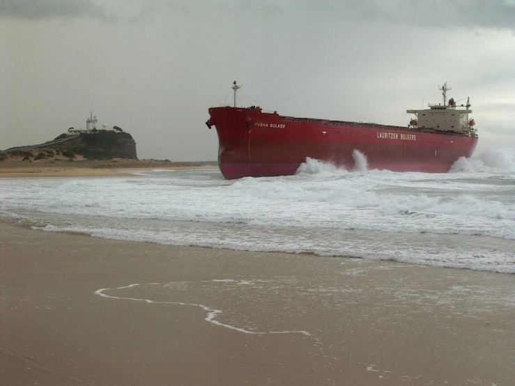 the large tanker ship is approaching the beach