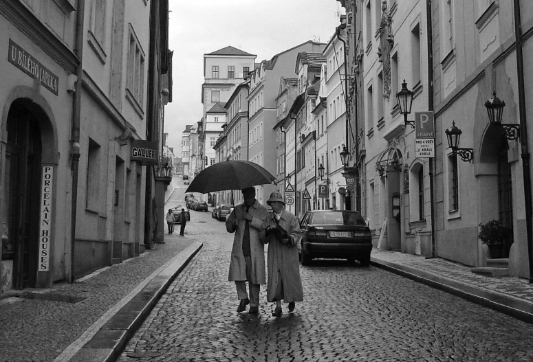 a group of people holding umbrellas walking down a street