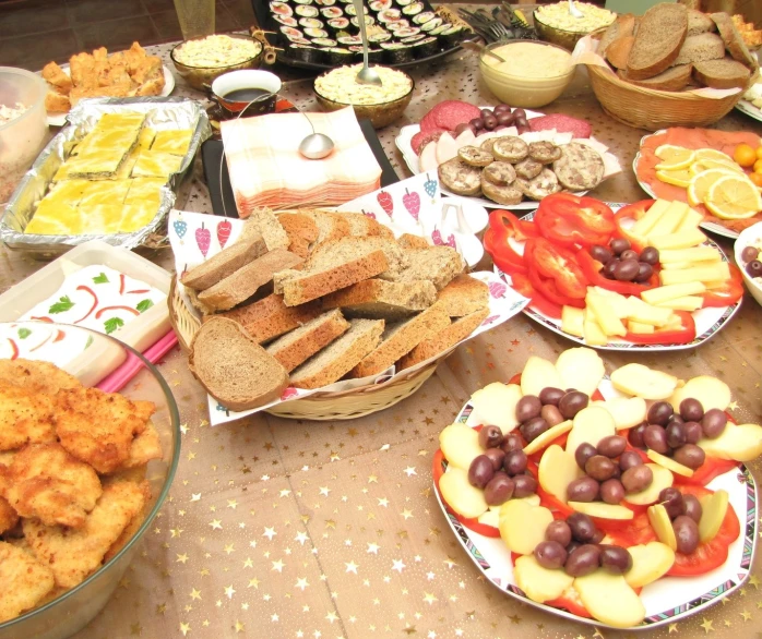 many dishes of snacks are placed on a table