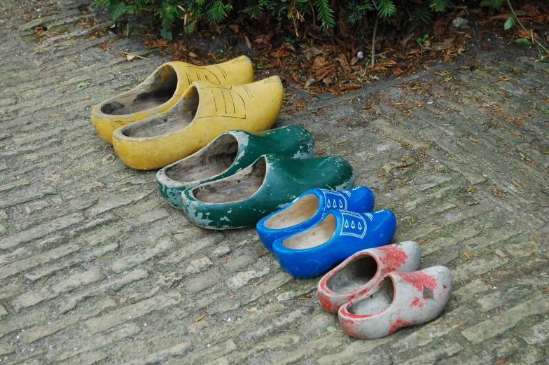 five different colored shoes sitting next to each other