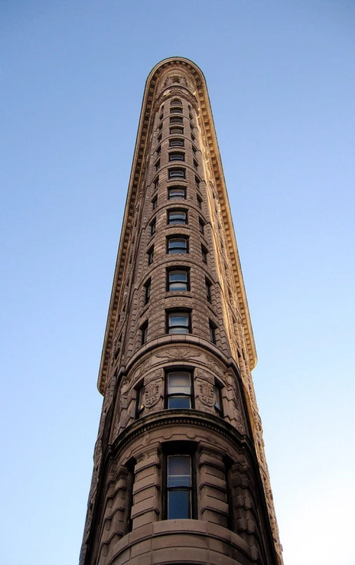 a tall building is shown against a clear blue sky