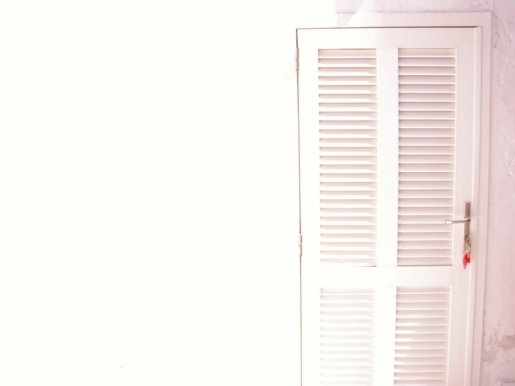 the inside of a white door in a small room
