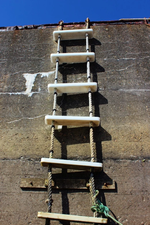 there is a ladder that appears to have ropes connected to it