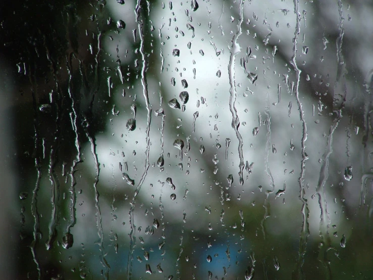 the rain is coming down on a window