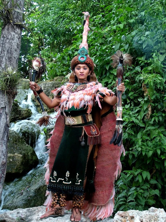 a woman in costume is holding two wands