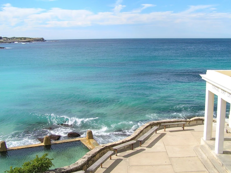 a view of the ocean and beach from a porch