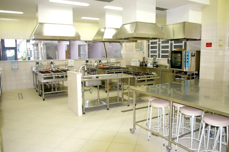 a large kitchen with stainless steel appliances and counters