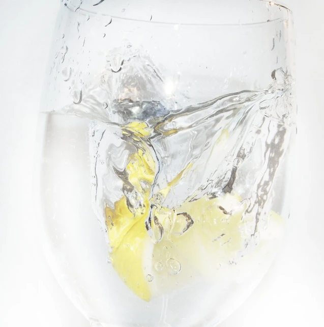 a drink of water and lemon wedges is in a glass