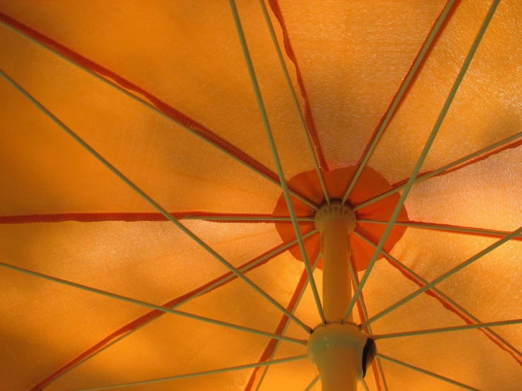 a close up of the inside of an orange umbrella