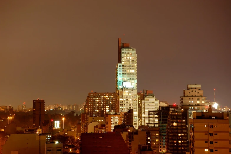 the view of a city skyline with buildings lit up