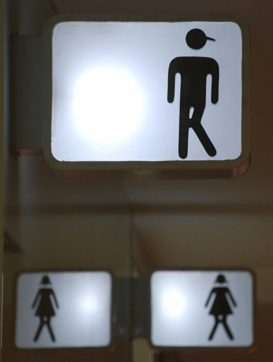the bathroom sign has several symbols for the men and women