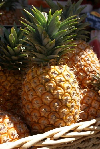 a large basket full of pineapples next to each other