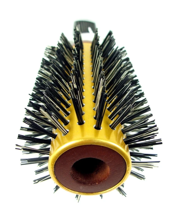 a yellow brush holder is filled with long black brush