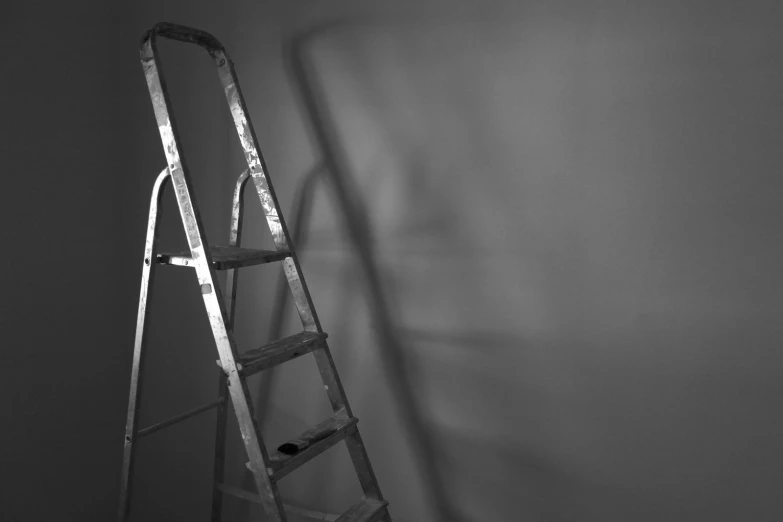 a ladder leaning against a wall with the light turned on