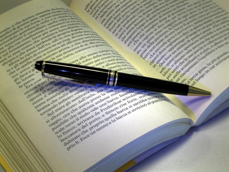 a pen on top of an open book