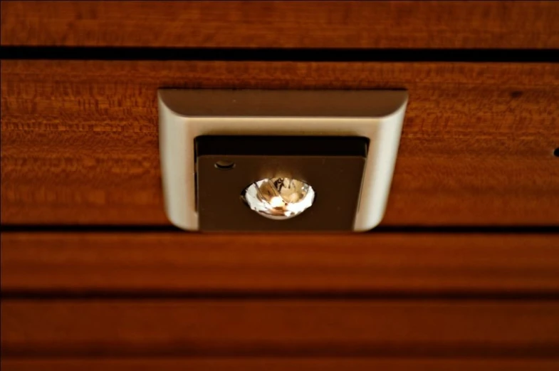 the door handle of a wood drawer has a hole