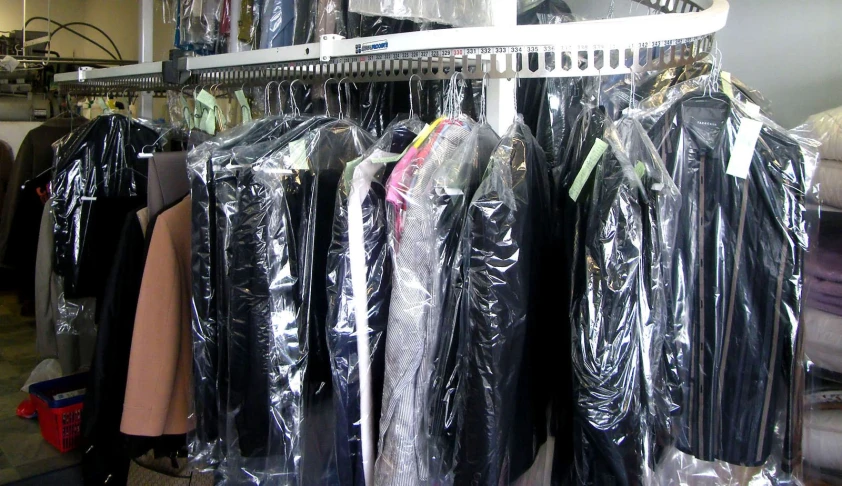 a rack of coat covers in a clothing store